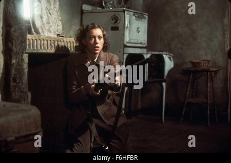 1977, Film Title: EAGLE HAS LANDED, Director: JOHN STURGES, Pictured: 1977, JENNY AGUTTER, JOHN STURGES, WEAPON, GUN, KNEELING, CROUCHING, ON KNEES, POOR, POVERTY, WAR, FIREPLACE, INTERIOR. (Credit Image: SNAP) Stock Photo