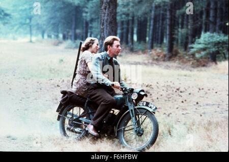 1977, Film Title: EAGLE HAS LANDED, Director: JOHN STURGES, Pictured: JENNY AGUTTER, MOTORCYCLE, GUN, DONALD SUTHERLAND, VEHICLE, TANDEM, DOUBLE, PASSENGER, FOREST, WOOD, RIDING, WAR. (Credit Image: SNAP) Stock Photo