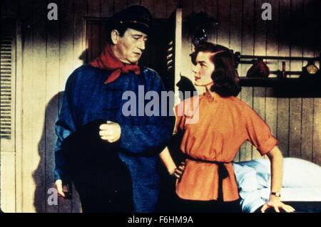 1955, Film Title: BLOOD ALLEY, Director: WILLIAM WELLMAN, Studio: WARNER, Pictured: LAUREN BACALL, JOHN WAYNE, HAND ON HIP, DEFIANT, STUBBORN, ASSERTIVE, CONFLICT, CONFRONTATION, NECK SCARF, CABIN, SHIP, DEFENSIVE, BOAT, ADVENTURE. (Credit Image: SNAP) Stock Photo