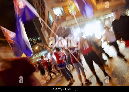 Mong Kok, Hong Kong. 17th Nov, 2015, Hong Kong v China for World Cup qualification. Outside Mong Kok Stadium, Hong Kong football fans show there differences to the mainland by waving the old British colonial flag of Hong Kong. Alistair Ruff/Alamy Live News Stock Photo