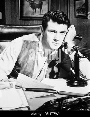 1955, Film Title: GIANT, Director: GEORGE STEVENS, Studio: WARNER, Pictured: ROCK HUDSON, DESK, TELEPHONING, OFFICE, PAPER WORK, GLUM, OVER WORKED. (Credit Image: SNAP) Stock Photo