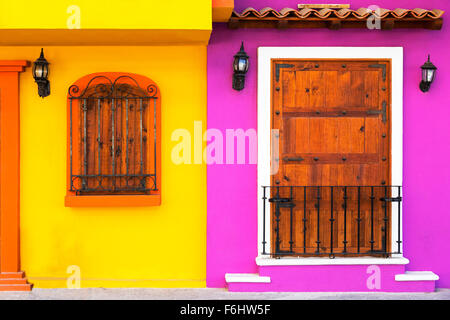 Purple and yellow building detail with wooden windows, Puerto Vallarta, Mexico Stock Photo