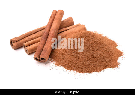 Ground cinnamon and cinnamon sticks isolated on white Stock Photo