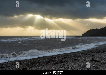 UK Weather, Lyme Regis, Dorset, UK.  17th November 2015.  Rays of light shining through the clouds off the coast of Lyme Regis in Dorset, UK, during a day of strong winds and rough seas caused by the storm Barney. Picture:  ©Graham Hunt/Alamy Live News Stock Photo