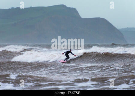 UK Weather, Lyme Regis, Dorset, UK.  17th November 2015. A surfer enjoying the waves off the coast of Lyme Regis in Dorset, UK, during a day of strong winds and rough seas caused by the storm Barney. Picture:  ©Graham Hunt/Alamy Live News Stock Photo