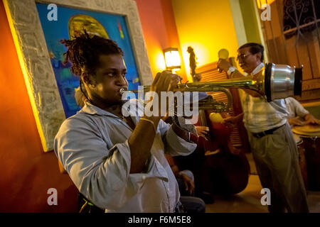 Musicians in one of the many music bars and restaurants of Havana Music, trumpeter with damper takes place in a bar, Cuba, Stock Photo