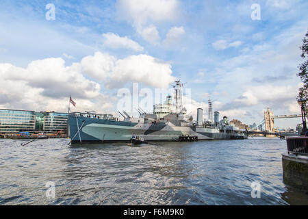 The iconic HMS Belfast light cruiser, a popular museum and tourist attraction, moored on the River Thames in the Pool of London Stock Photo