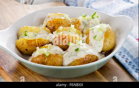 Hot Baked potato with chives and cream. Selective focus Stock Photo