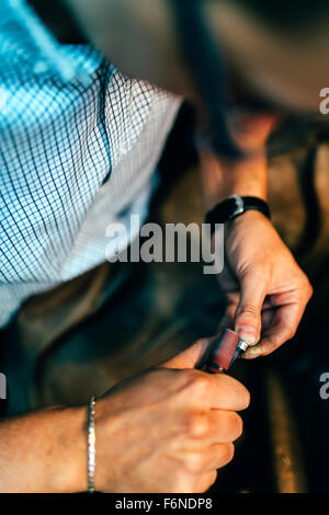 Jewelery polishing ring in workshop with adequate tools Stock Photo