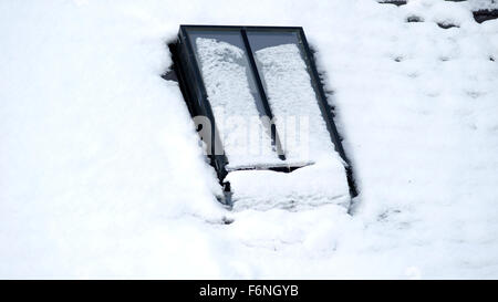 Conservation style velux window on the roof of a converted steading in Scotland, almost covered in snow Stock Photo