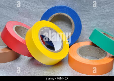 Set of multicolored insulating tapes on metal grey background Stock Photo