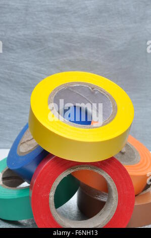 Set of multicolored insulating tapes on metal grey background Stock Photo