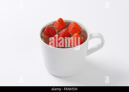 mug of strawberries in chocolate pudding on white background Stock Photo