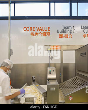 Detail of industrial bakery with production line. BreadTalk IHQ, Singapore, Singapore. Architect: Kay Ngeee Tan Architects, 2014 Stock Photo