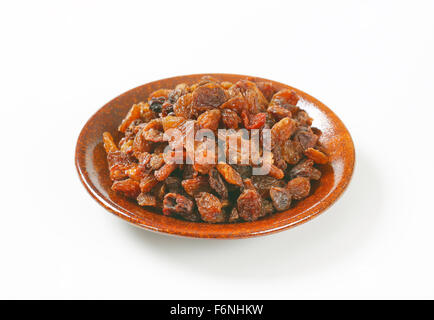 plate of raisins on white background Stock Photo