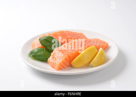 two raw salmon fillets on white plate Stock Photo