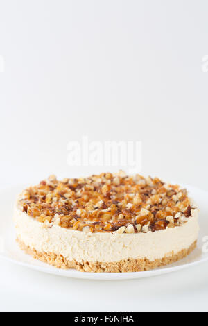 Homemade coconut cheesecake with caramel and assorted nuts Stock Photo
