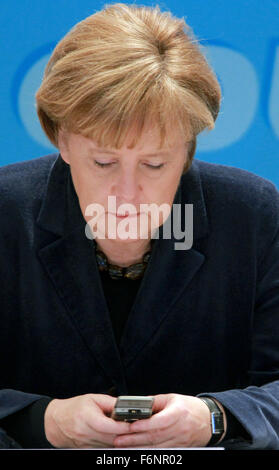 FILE - An archive picture, dated 22 January 2011, shows German Chancellor Angela Merkel (CDU) typing into her mobile phone during a CDU party conference in Guestrow, Germany. Photo: Jens Buettner/dpa Stock Photo