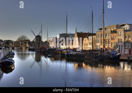 Leiden Canal with windmill in distance Stock Photo