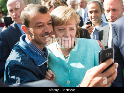 FILE - An archive picture dated 10 September 2015 shows German Chancellor Angela Merkel (CDU, R) taking a selfie with a refugee at the refugee reception centre in Berlin, Germany. Photo: Bernd von Jutrczenka/dpa Stock Photo