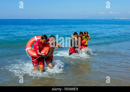 Lifeguards on the beach at Puerto Vallarta, Mexico undergoing training in rescue and lifesaving as part of their licence require Stock Photo