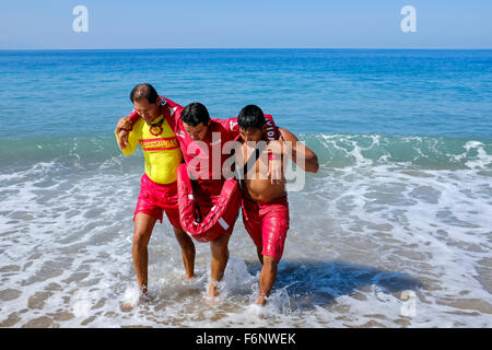 Lifeguards on the beach at Puerto Vallarta, Mexico undergoing training in rescue and lifesaving as part of their licence require Stock Photo