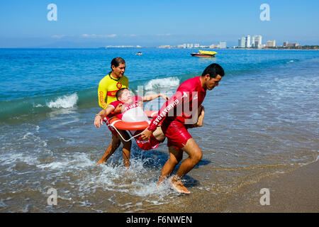 Lifeguards on the beach at Puerto Vallarta, Mexico undergoing training in rescue and lifesaving as part of their licence require Stock Photo