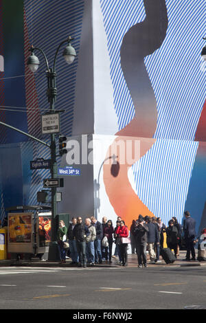 People wait to cross 8th Ave. at 34th Street on the West side of Manhattan. Stock Photo