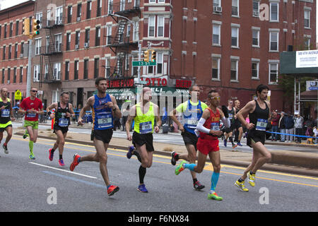 Runners race up 4th Avenue through Park Slope Brooklyn during the 1st leg of the NY City Marathon. Stock Photo