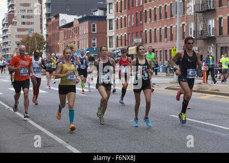Runners race up 4th Avenue through Park Slope Brooklyn during the 1st leg of the NY City Marathon. Stock Photo