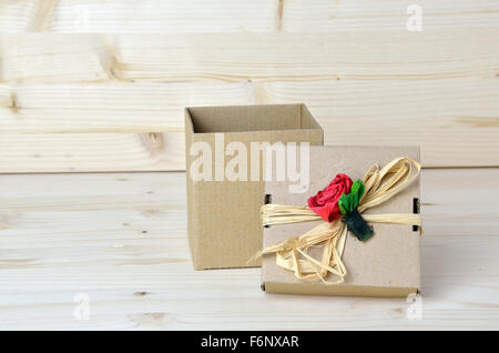 Opened gift cardboard box with red paper rose on its lid Stock Photo