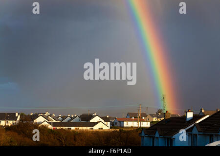 Rainbow over social or council housing in Burtonport, County Donegal, Ireland Stock Photo