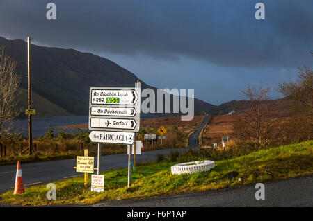 Gaelic language roadsign at Fintown, County Donegal, Ireland. The landscape in November. Stock Photo