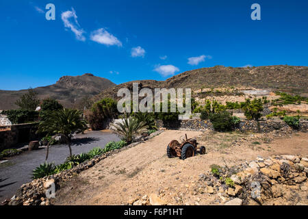 Old vintage rusting tractor abandoned in a field at a finca near San Miguel, Tenerife, Canary Islands, Spain, Stock Photo