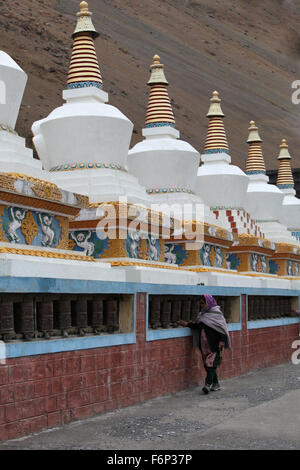 SPITI VALLEY - Devotee spinning Prayer wheels outside Kaza Monastery in Kaza village, Himachal Pradesh, India Stock Photo