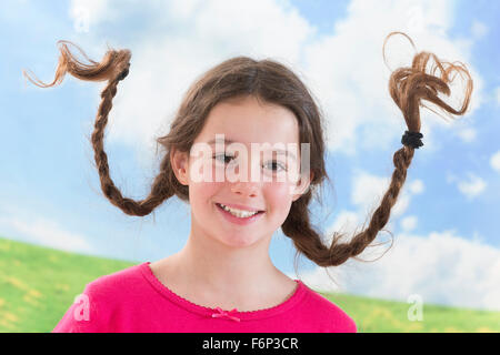 Cute little girl with long braided hair up Stock Photo