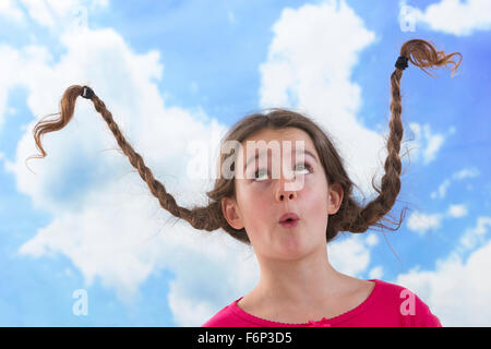 Cute little girl with long braided hair up Stock Photo