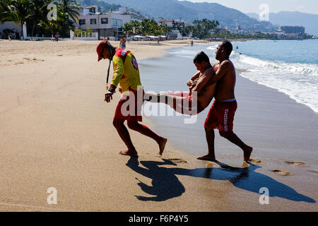 Lifeguards on the beach at Puerto Vallarta, Mexico undergoing training in rescue and lifesaving as part of their licence require Stock Photo