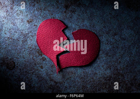 Broken Paper Heart on Blue Grunge Surface Stock Photo