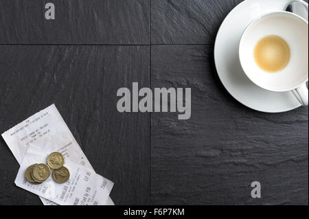 Restaurant leaving a gratuity and bill paying. Leaving a tip after a meal. Stock Photo