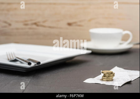 Bill or check with a tip.Restaurant leaving a gratuity and bill paying. Leaving a tip after a meal. Stock Photo