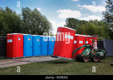 Placement of rows of colourful portable toilets at outdoor event