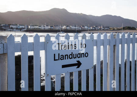 Trains to Llandudno sign with arrow on the railway station at Deganwy North Wales Stock Photo