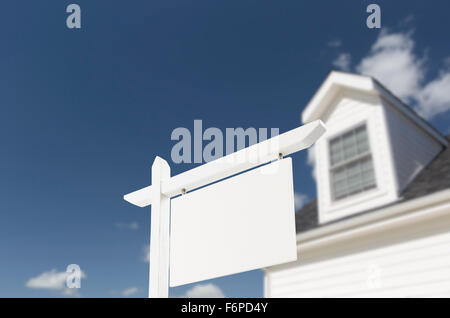 Blank Real Estate Sign in Front of Beautiful New House. Stock Photo