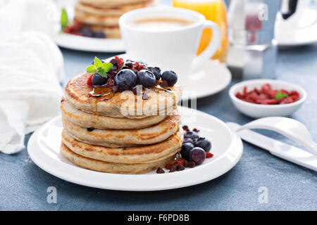 Fluffy chocolate chip pancakes on breakfast table Stock Photo