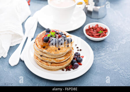 Fluffy chocolate chip pancakes on breakfast table Stock Photo