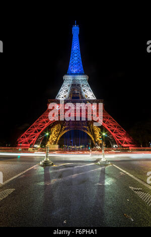 Eiffel Tower illuminated with French flag colors as tribute to the victims of November 13, 2015 attacks Stock Photo