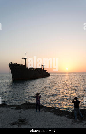 Taking Photos By Cell phones From Greek Ship Wreckage in Kish Island at Sunset Stock Photo