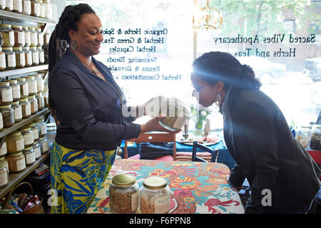 Black woman smelling tea in tea shop Stock Photo