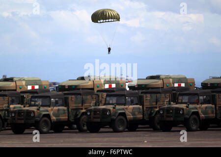 Pampanga Province, Philippines. 21st Dec, 2015. A paratrooper lands near a row of medical military trcuks during a parade in celebration of the 80th founding anniversary of the Armed Forces of the Philippines inside the Clark Air Base in Pampanga Province, the Philippines, Dec. 21, 2015. Credit:  Rouelle Umali/Xinhua/Alamy Live News Stock Photo